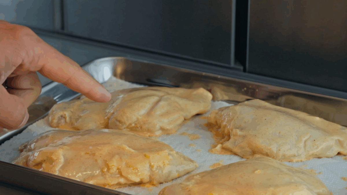 Marinated chicken chilling uncovered in the fridge. 