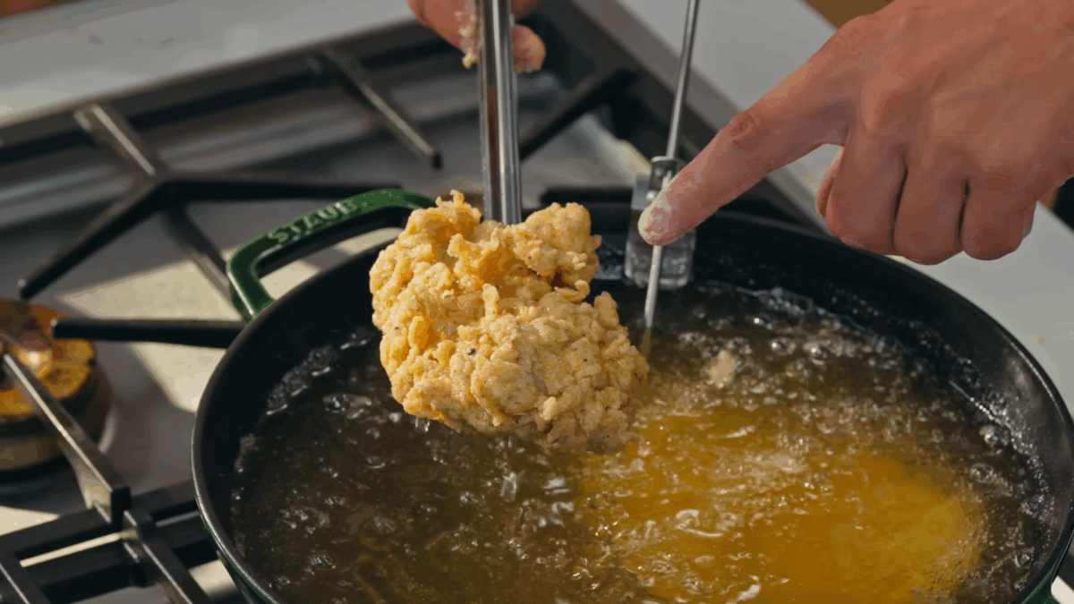 Nick DiGiovanni frying breaded chicken thighs. 