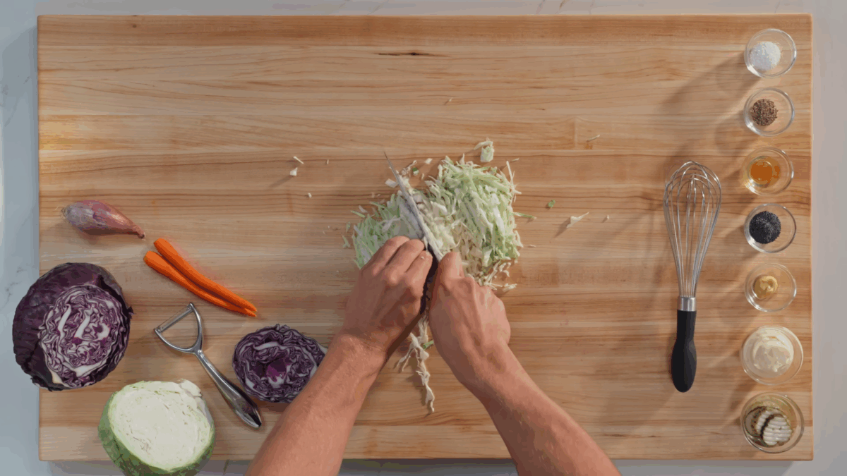 Nick DiGiovanni chopping green cabbage to make slaw. 