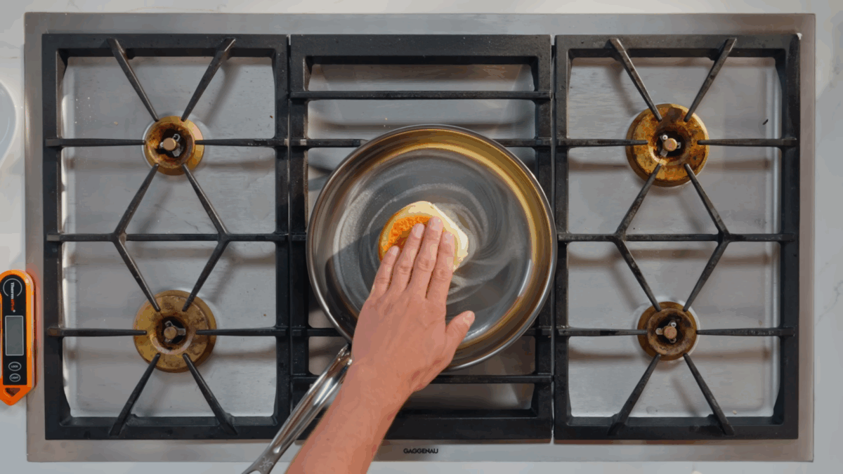 Nick DiGiovanni toasting sandwich buns in butter in a skillet. 
