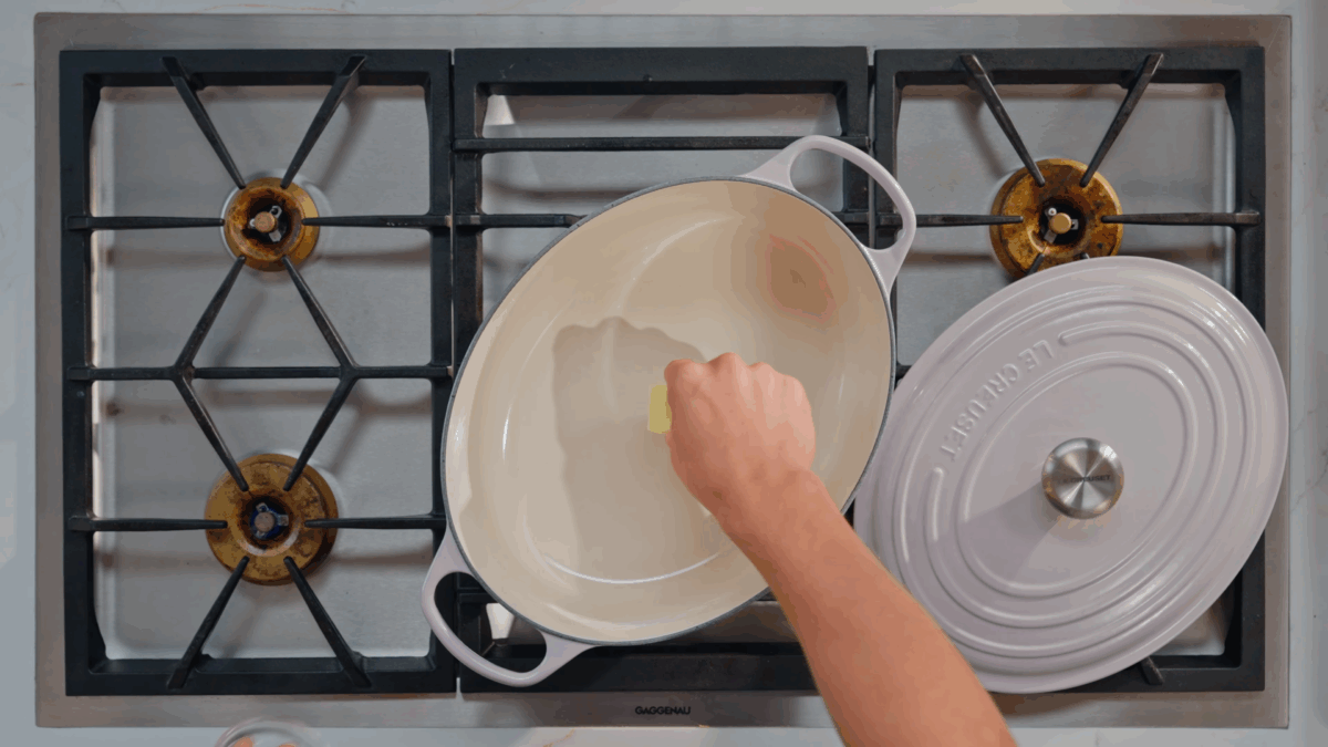 Nick DiGiovanni adding butter to a Dutch oven. 