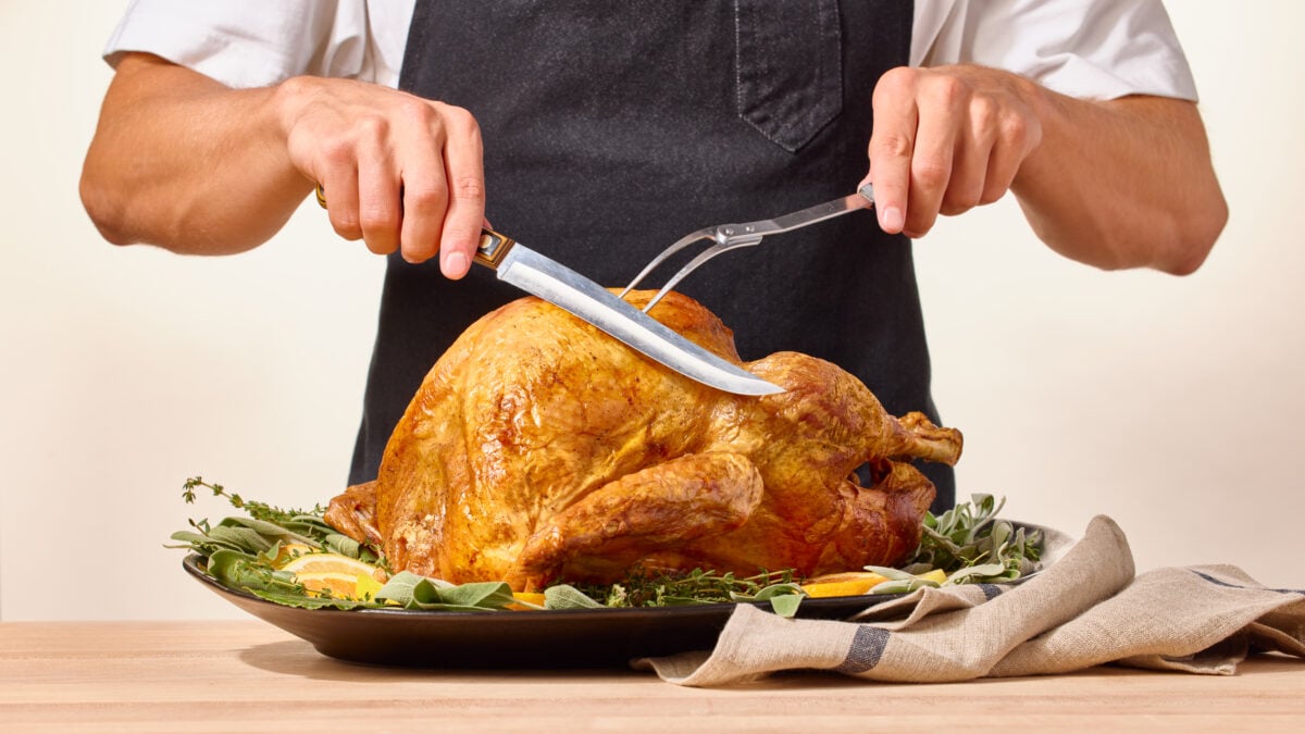Nick DiGiovanni carving a roasted spatchcock Thanksgiving turkey.