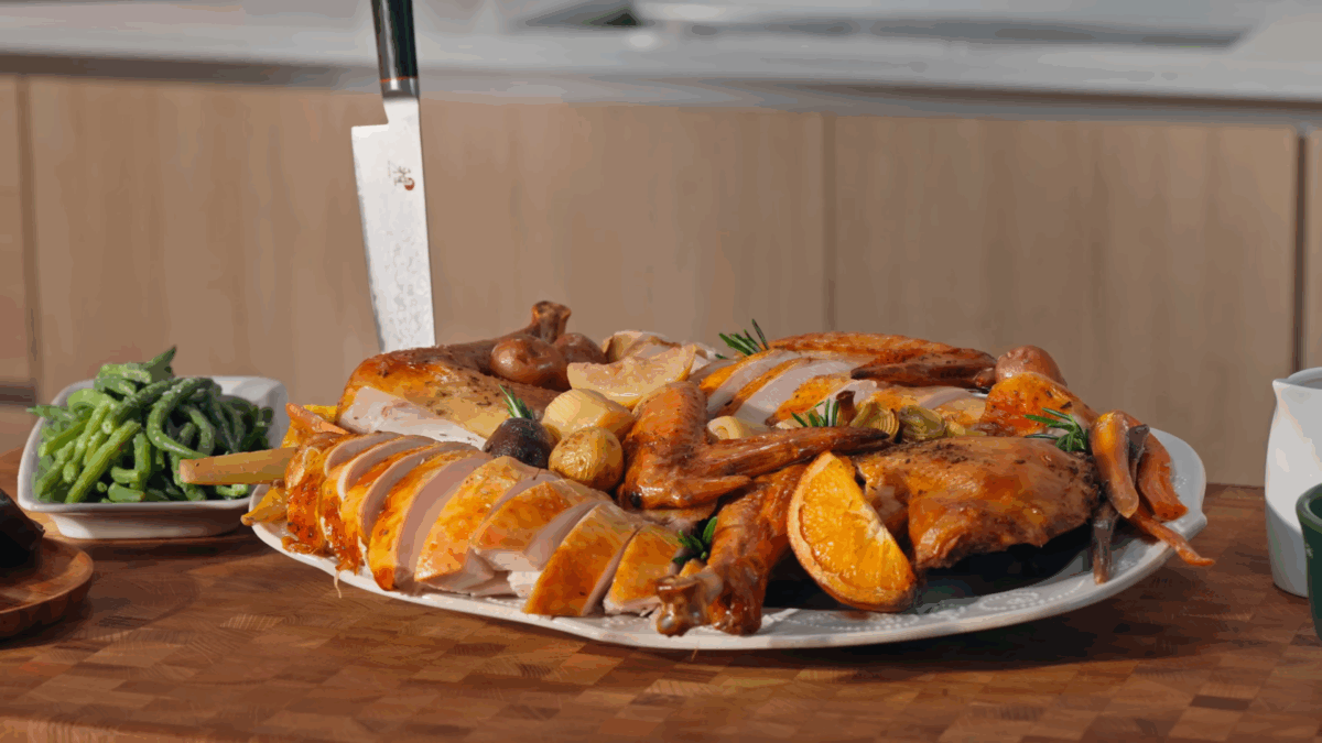 Thanksgiving turkey on a platter with roasted vegetables. 