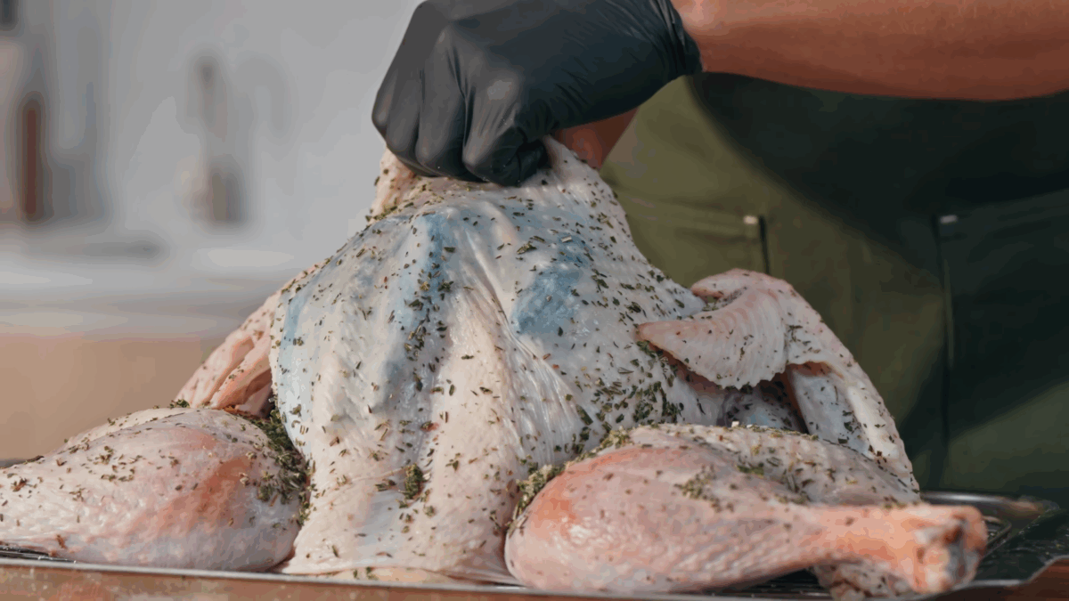 Nick DiGiovanni spreading compound butter under turkey skin. 