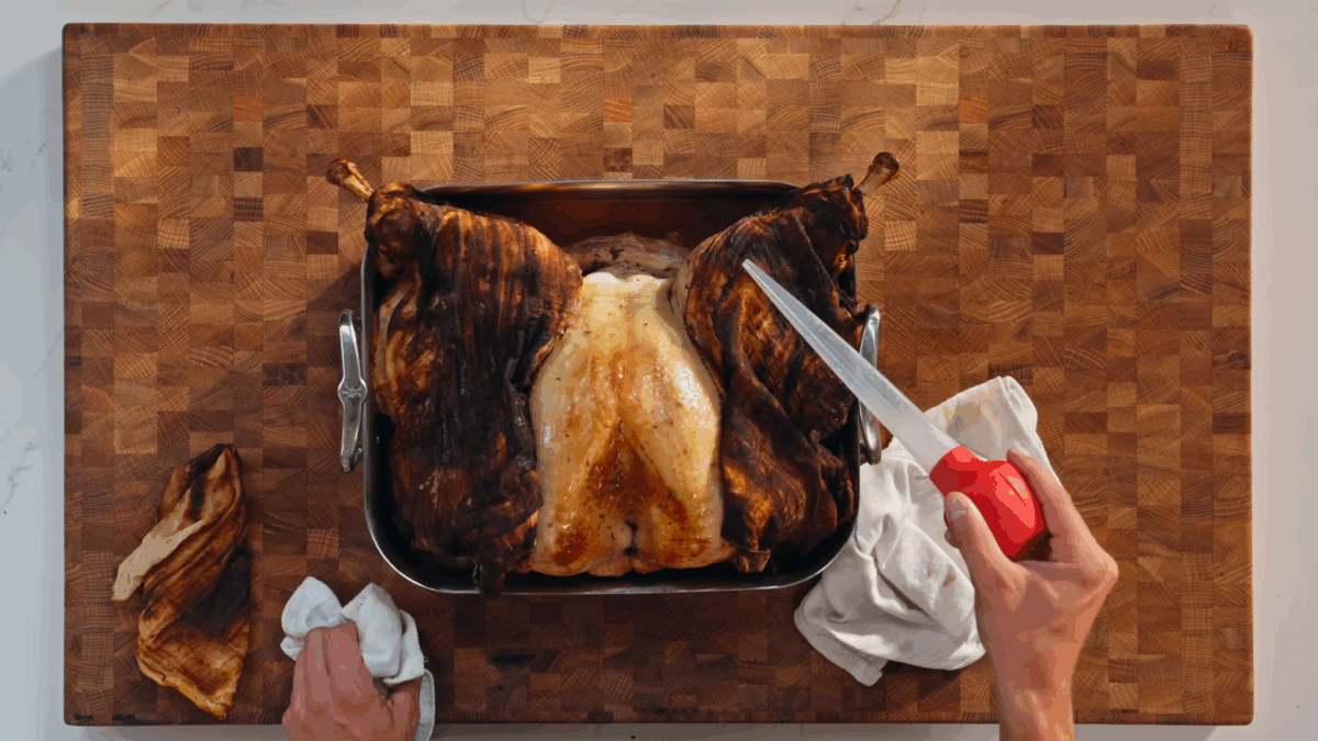 Nick DiGiovanni basting a Thanksgiving turkey. 