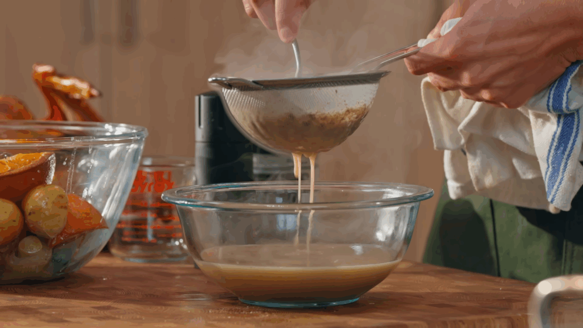 Nick DiGiovanni straining turkey gravy. 