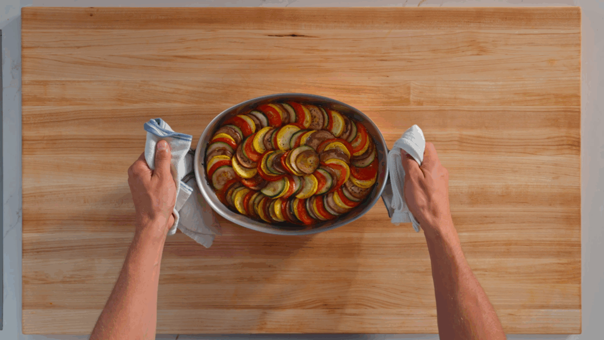 Nick DiGiovanni holding a dish of ratatouille.