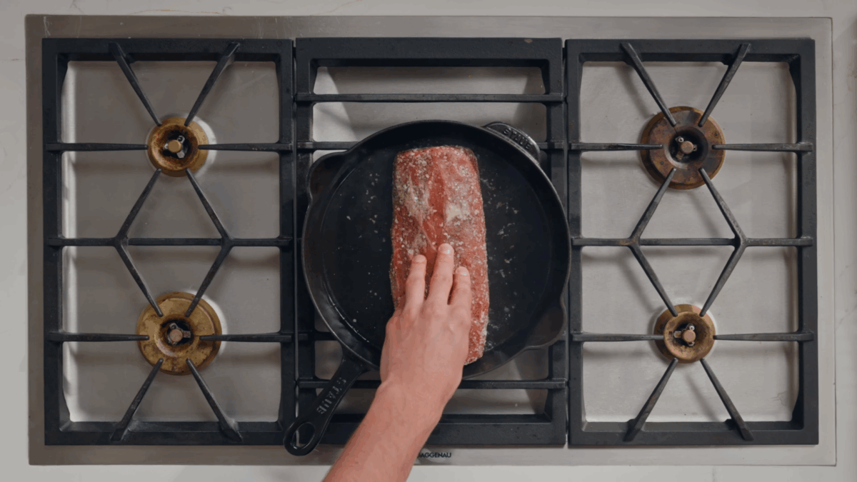 Nick DiGiovanni searing a beef tenderloin in a skillet. 