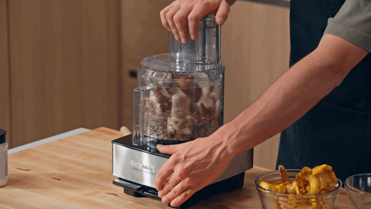 Nick DiGiovanni pulsing mushrooms in a food processor. 