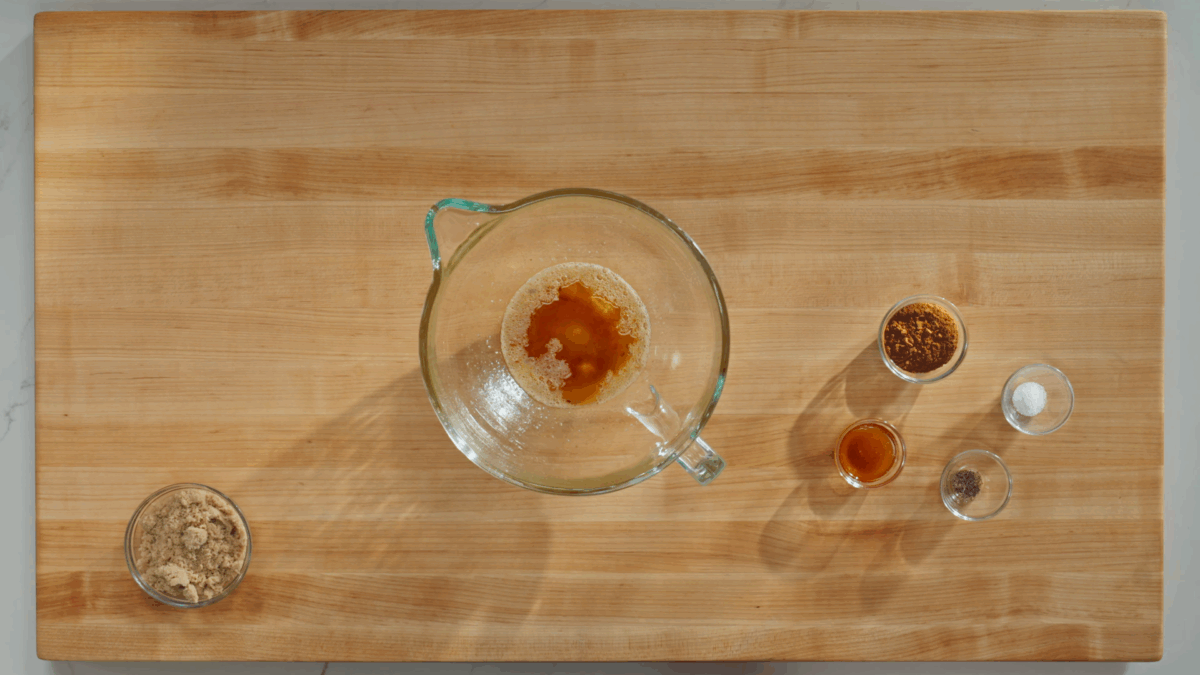 Brown butter in a glass bowl, spics next to it. 