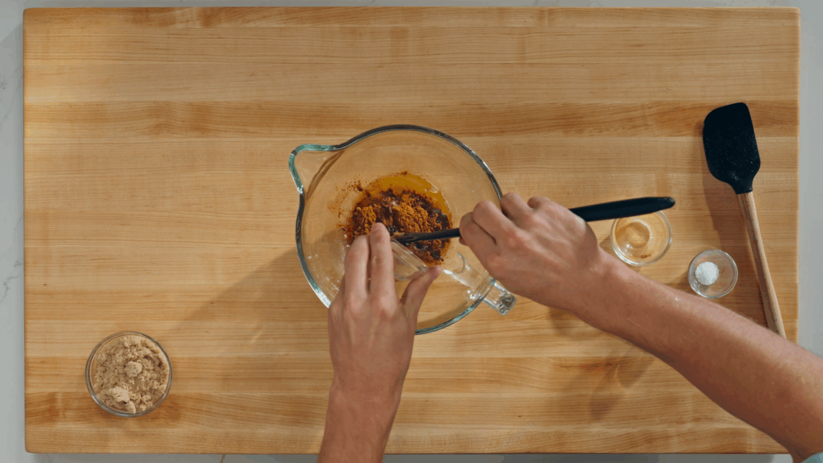 Nick DiGiovanni combining cinnamon roll filling ingredients in a bowl. 