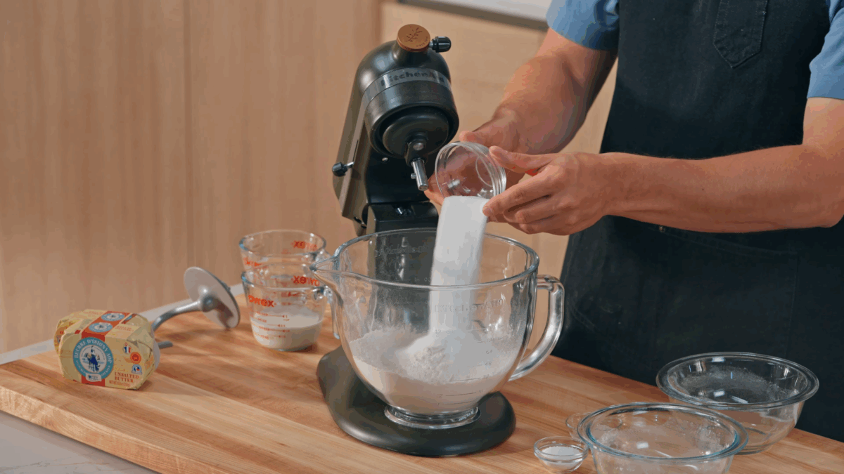 Nick DiGiovanni combining dry ingredients for homemade croissants in a stand mixer. 