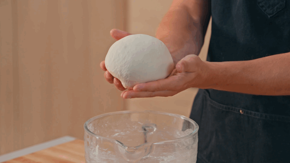 Nick DiGiovanni shaping croissant dough into a ball. 