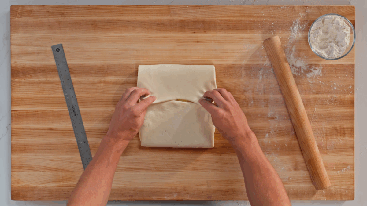 Nick DiGiovanni folding croissant dough over a block of butter. 