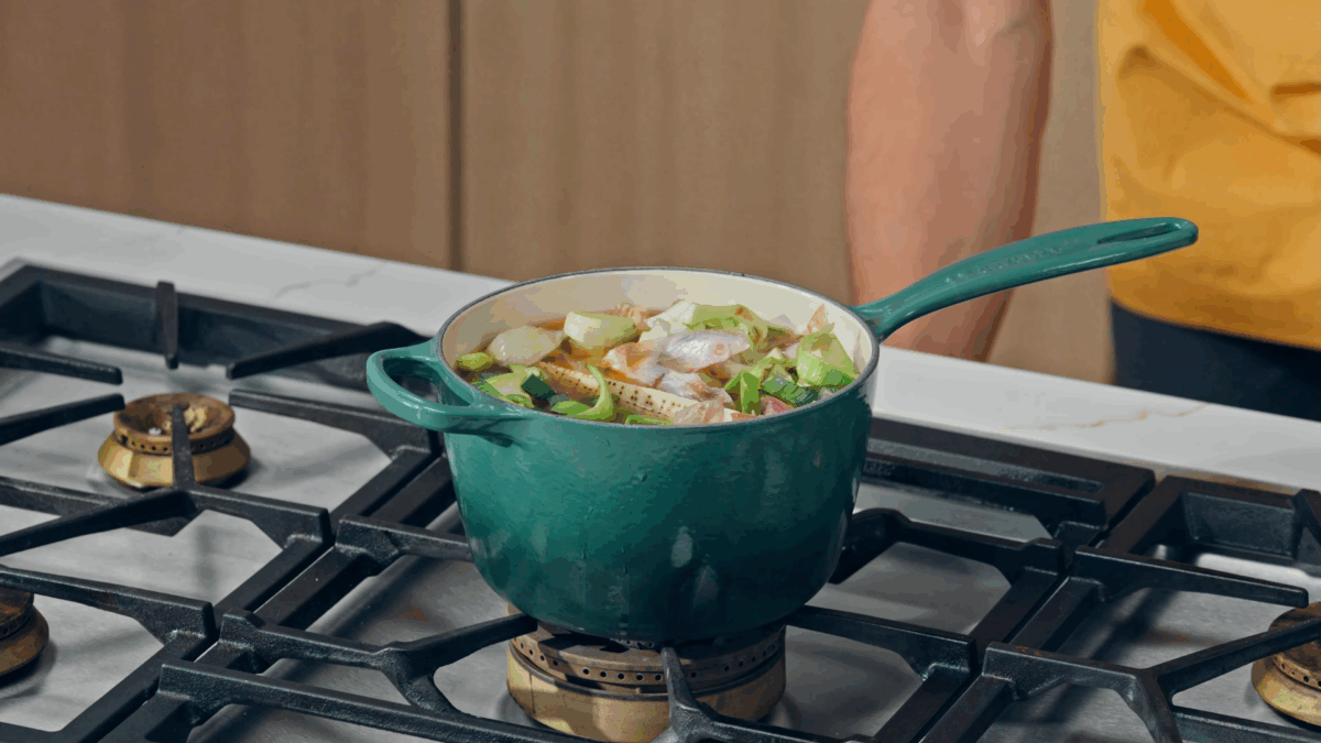 Fortified stock simmering in a pot on the stovetop.