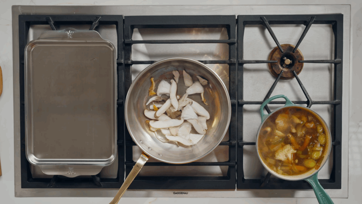 Mushrooms browning in an oiled skillet.