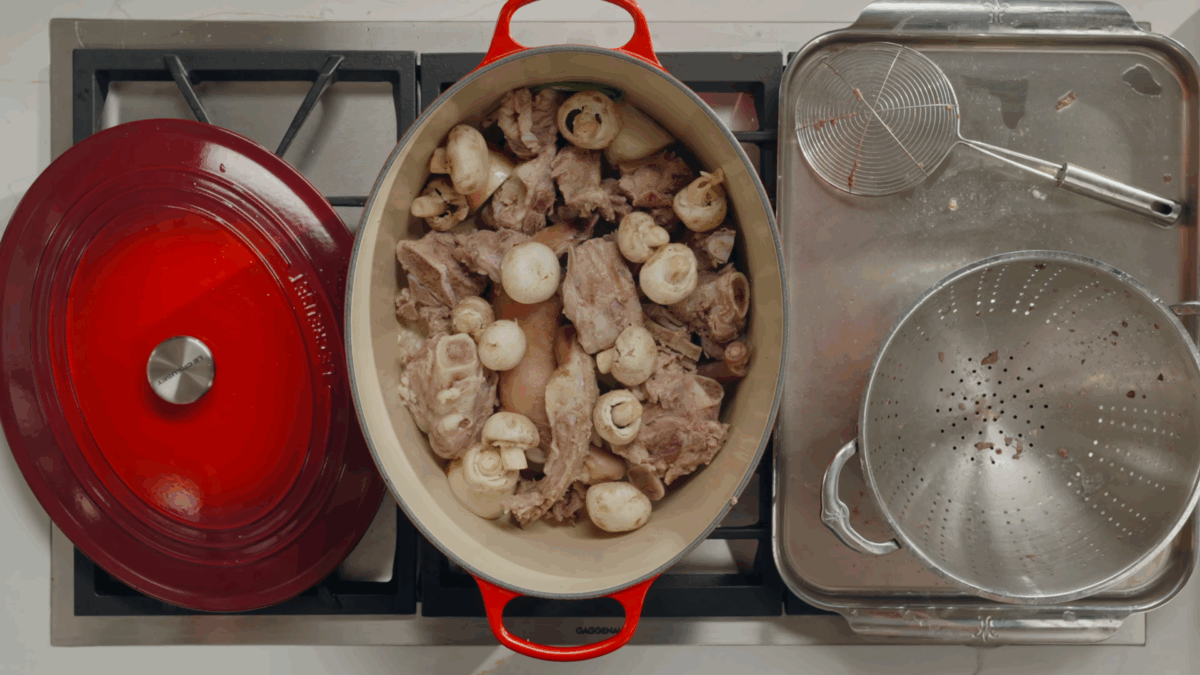 Pork broth ingredients in a large stock pot. 