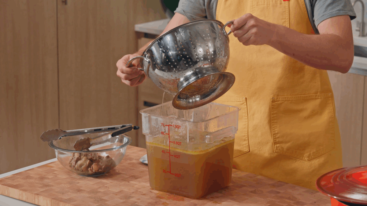 Nick DiGiovanni straining beef pho broth.