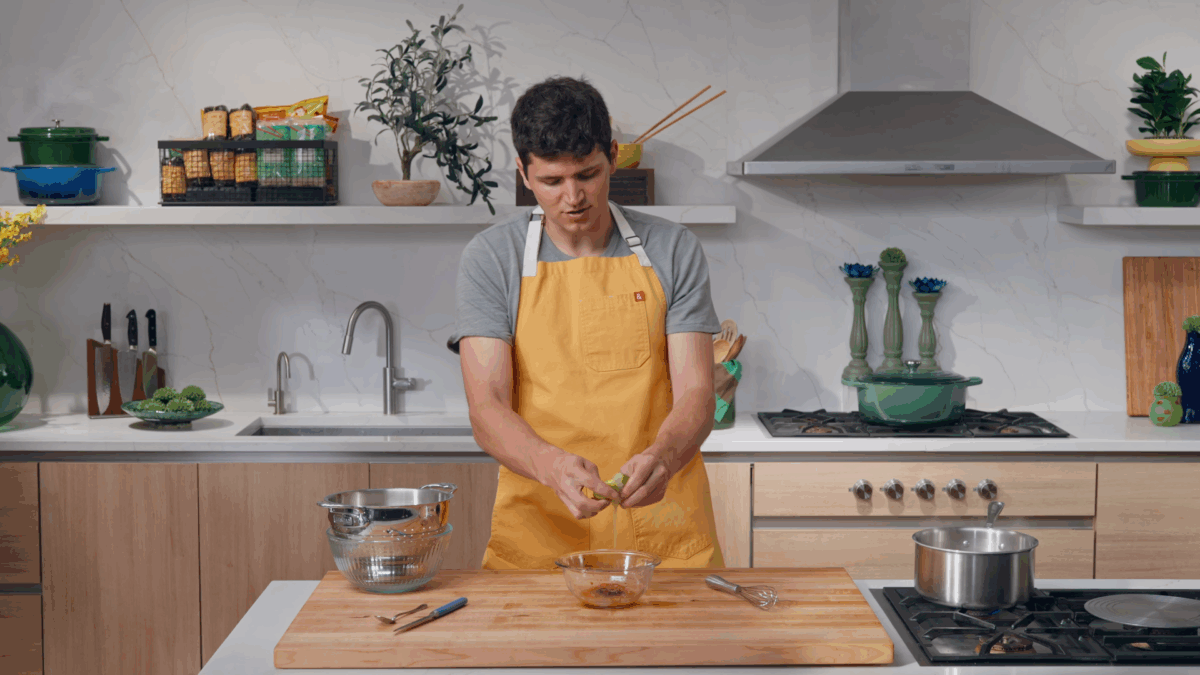 Nick DiGiovanni squeezing a lime into a bowl of sauce.