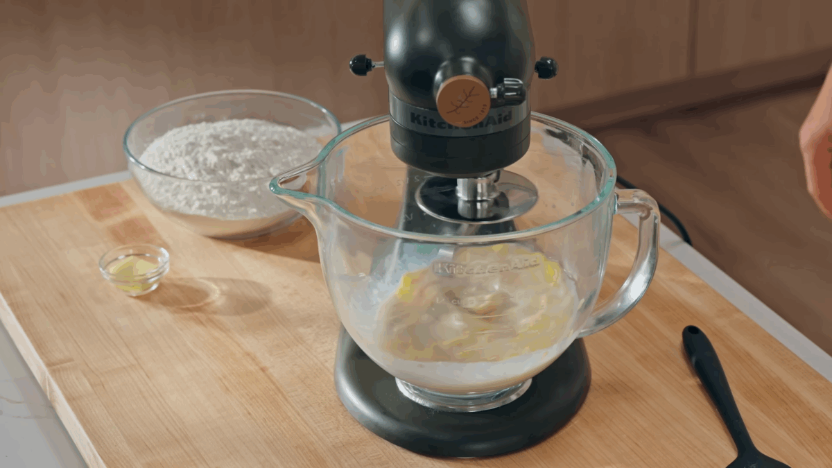 A stand mixer beating yeast donut dough. 