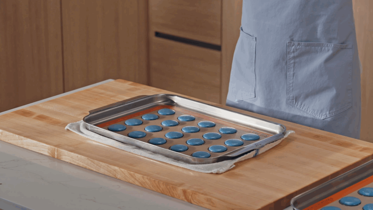 Nick DiGiovani releasing air bubbles from unbaked macaron shells. 