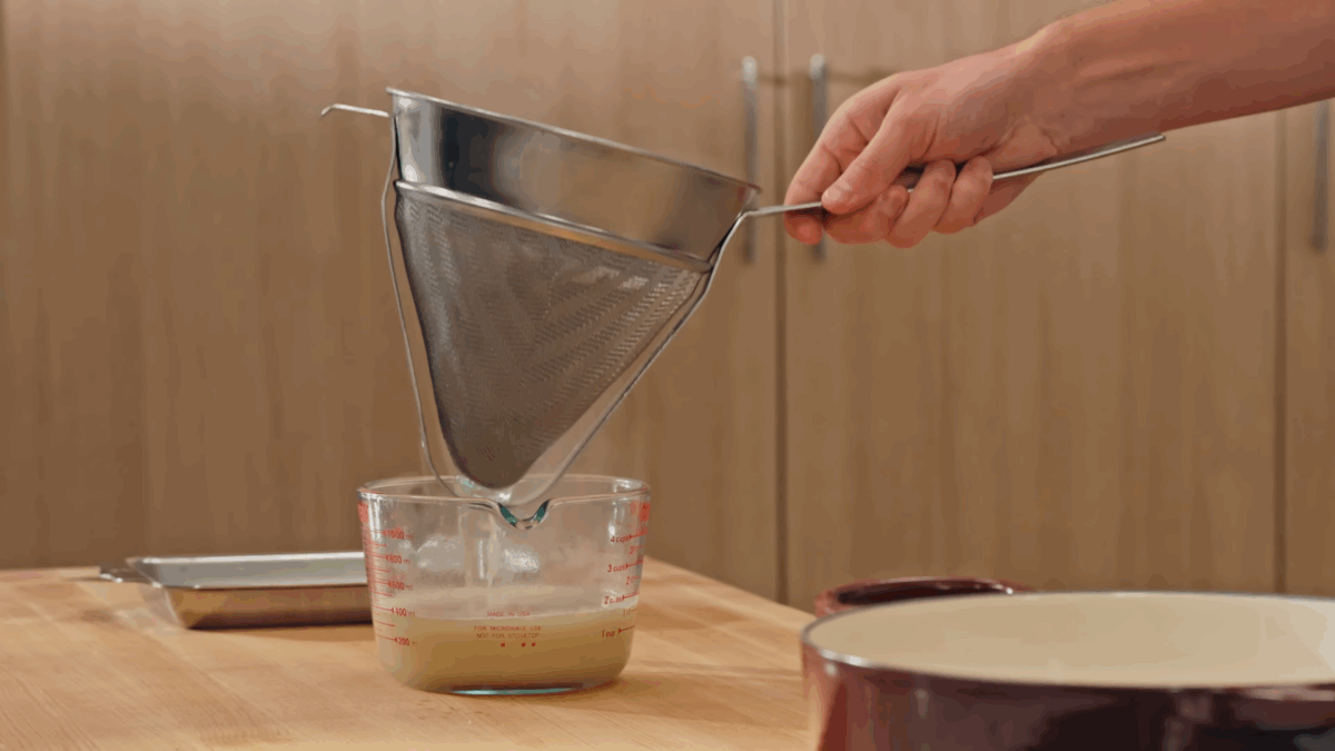 Nick DiGiovanni straining pork broth. 