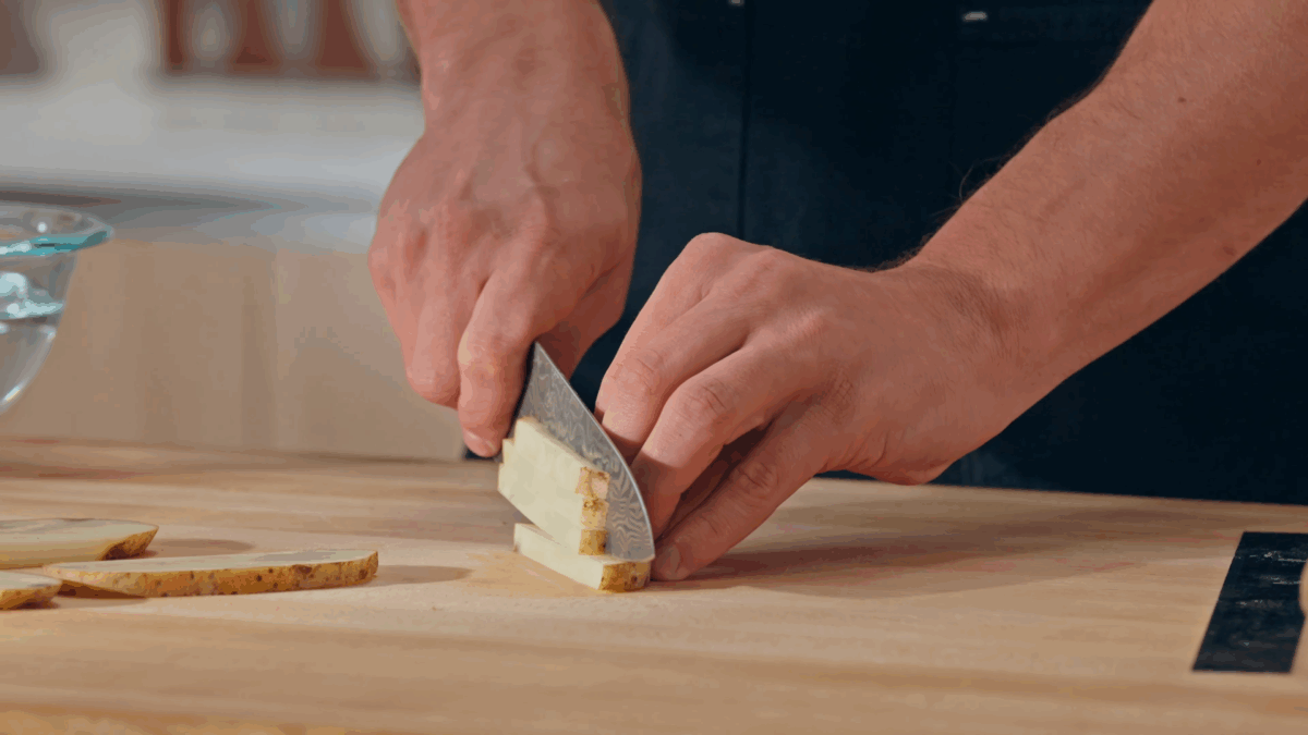 Nick DiGiovanni slicing a potato into fries.