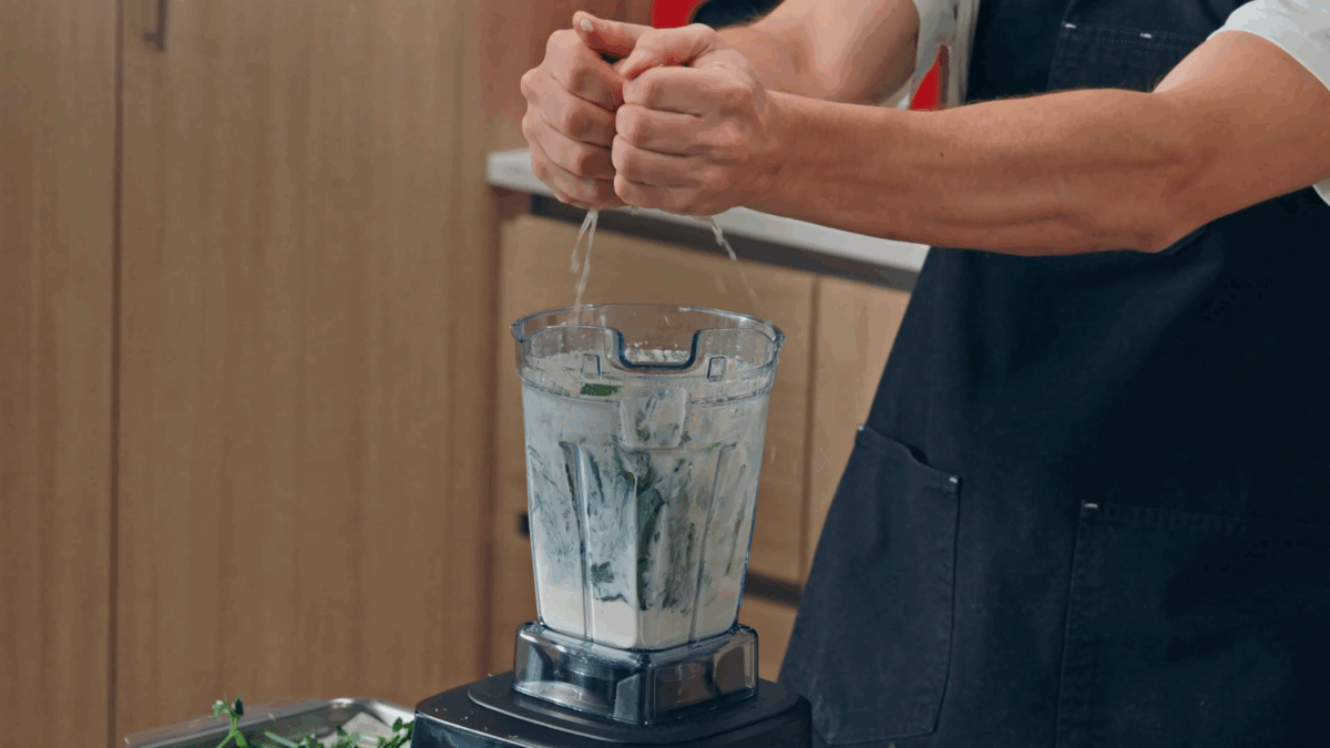 Nick DiGiovanni squeezing lemon juice into a blender.