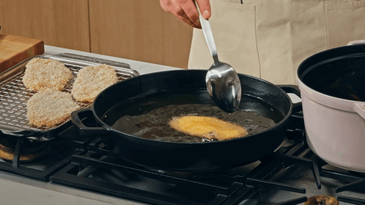 Nick DiGiovanni frying katsu chicken in oil on the stovetop.