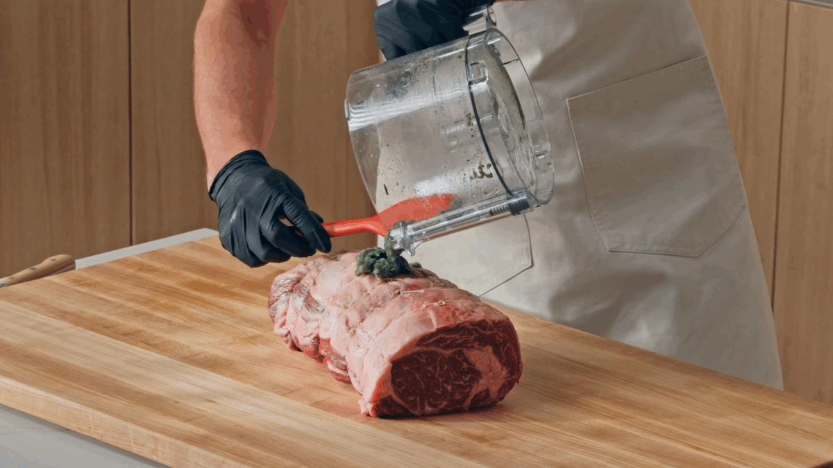 Nick DiGiovanni seasoning prime rib with an herb-salt blend.