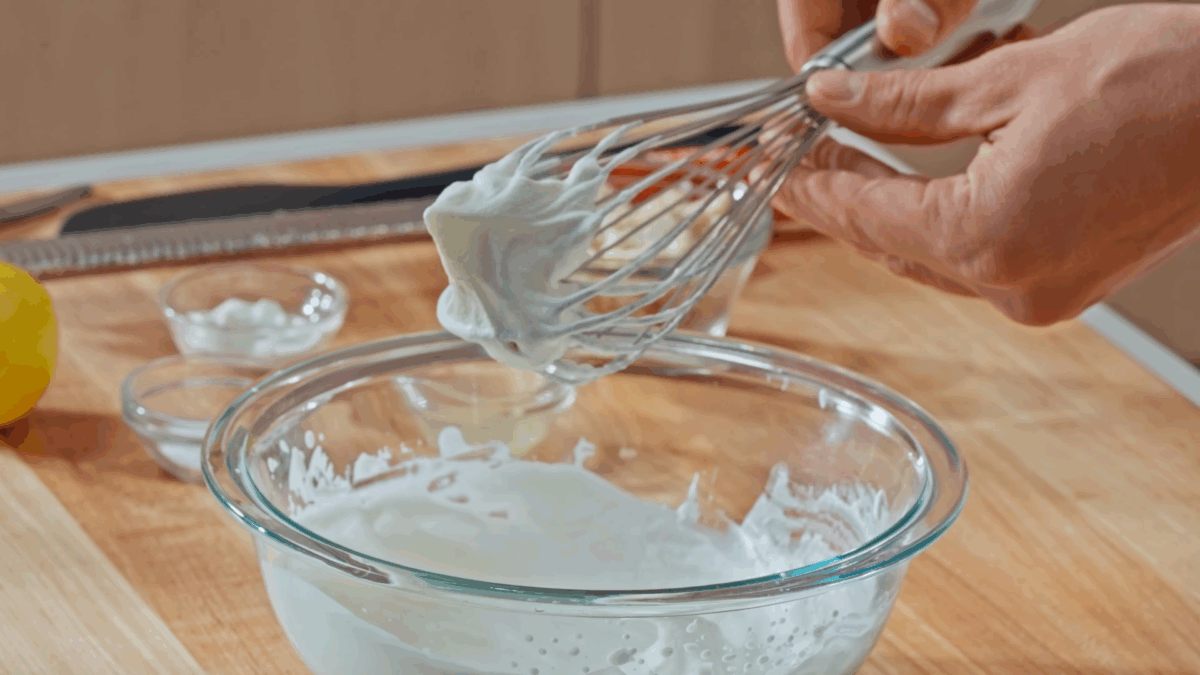 Nick DiGiovanni whipping heavy cream in a bowl.
