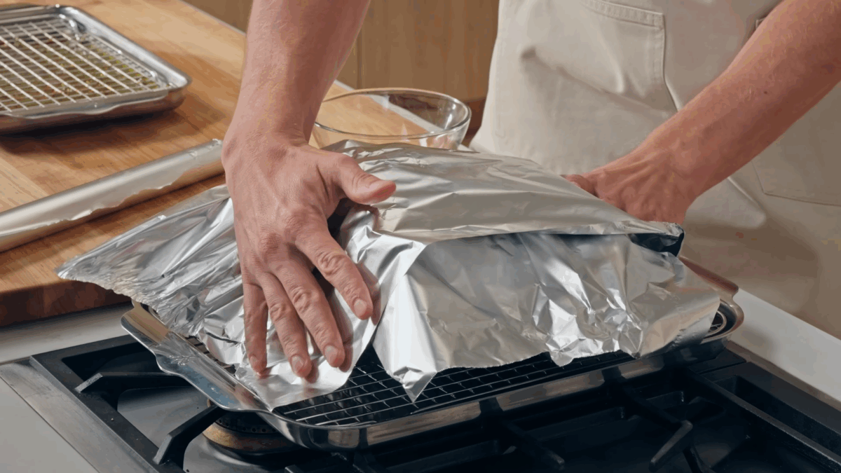 Nick DiGiovanni tenting prime rib with foil.