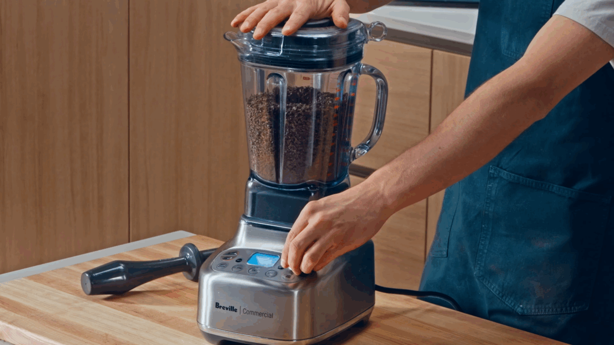 Nick DiGiovanni grinding cacao nibs in a blender. 