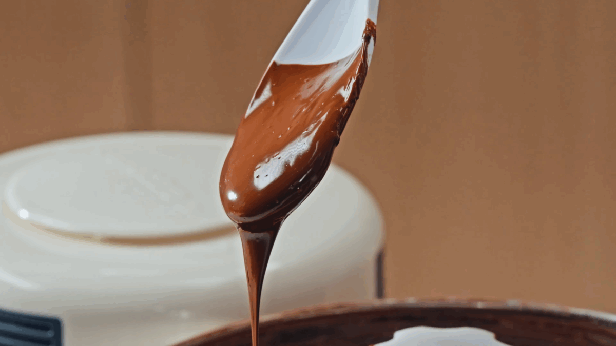 Nick DiGiovanni holding a spoon of melted chocolate. 