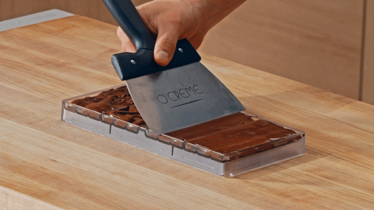 Nick DiGiovanni spreading homemade chocolate in silicone molds. 