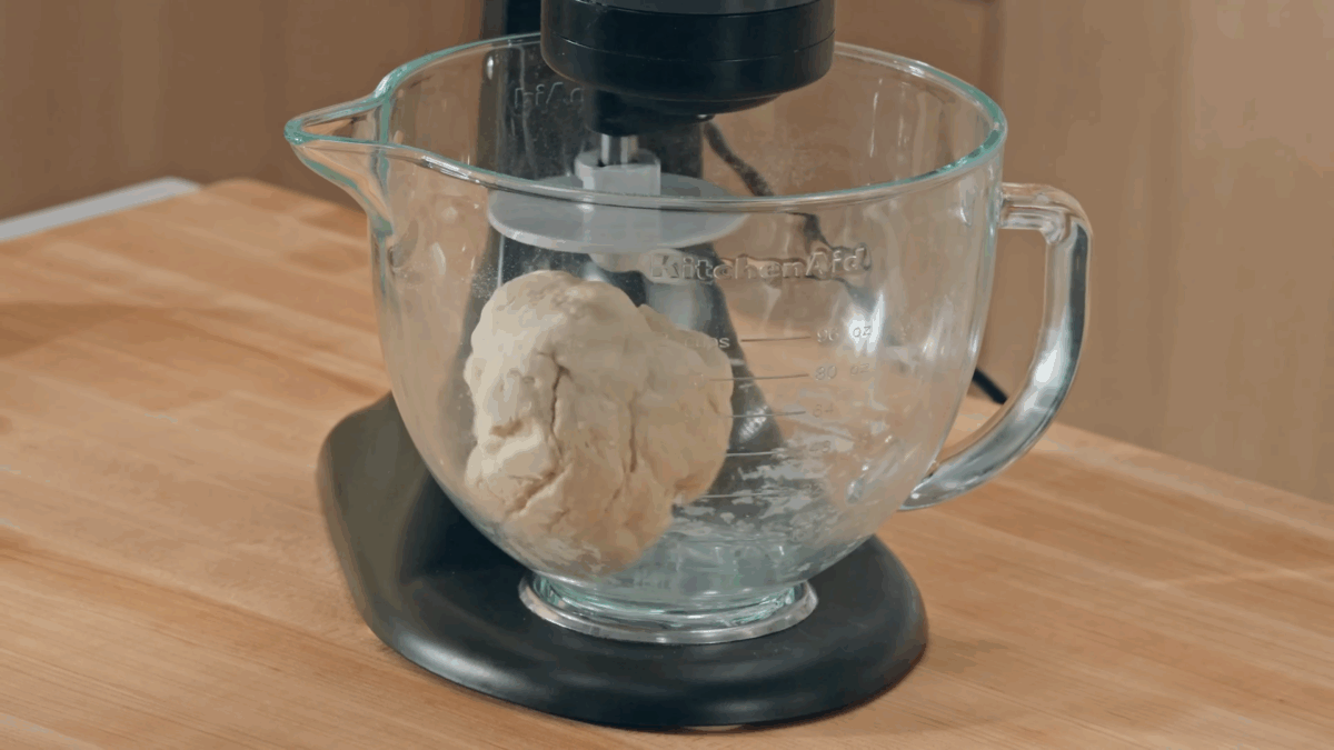 Pork soup dumpling dough in the bowl of a stand mixer. 