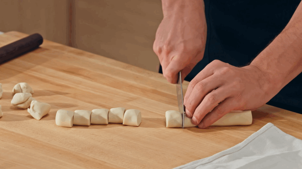 Nick DiGiovanni slicing pork soup dumpling dough.