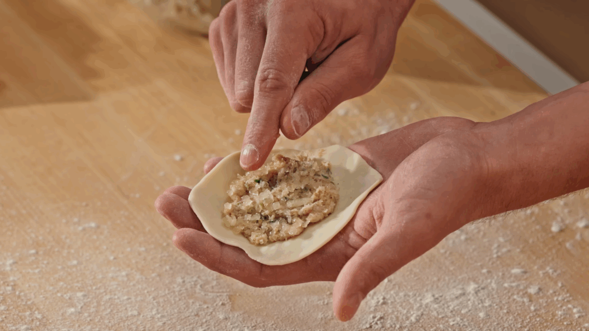 Nick DiGiovanni filling pork soup dumpling dough with a pork filling. 
