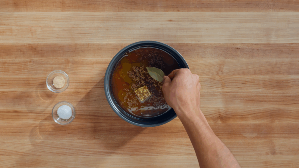Nick DiGiovanni combining ingredients for yellow turmeric rice in a rice cooker.