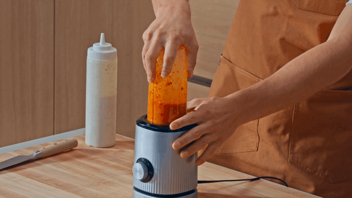 Nick DiGiovanni blending red sauce in a blender.