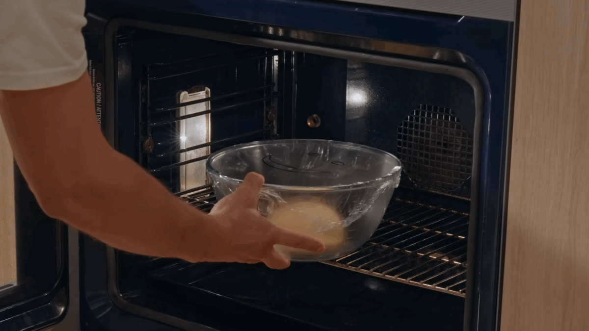Nick DiGiovanni transferring naan dough to an oven to proof. 