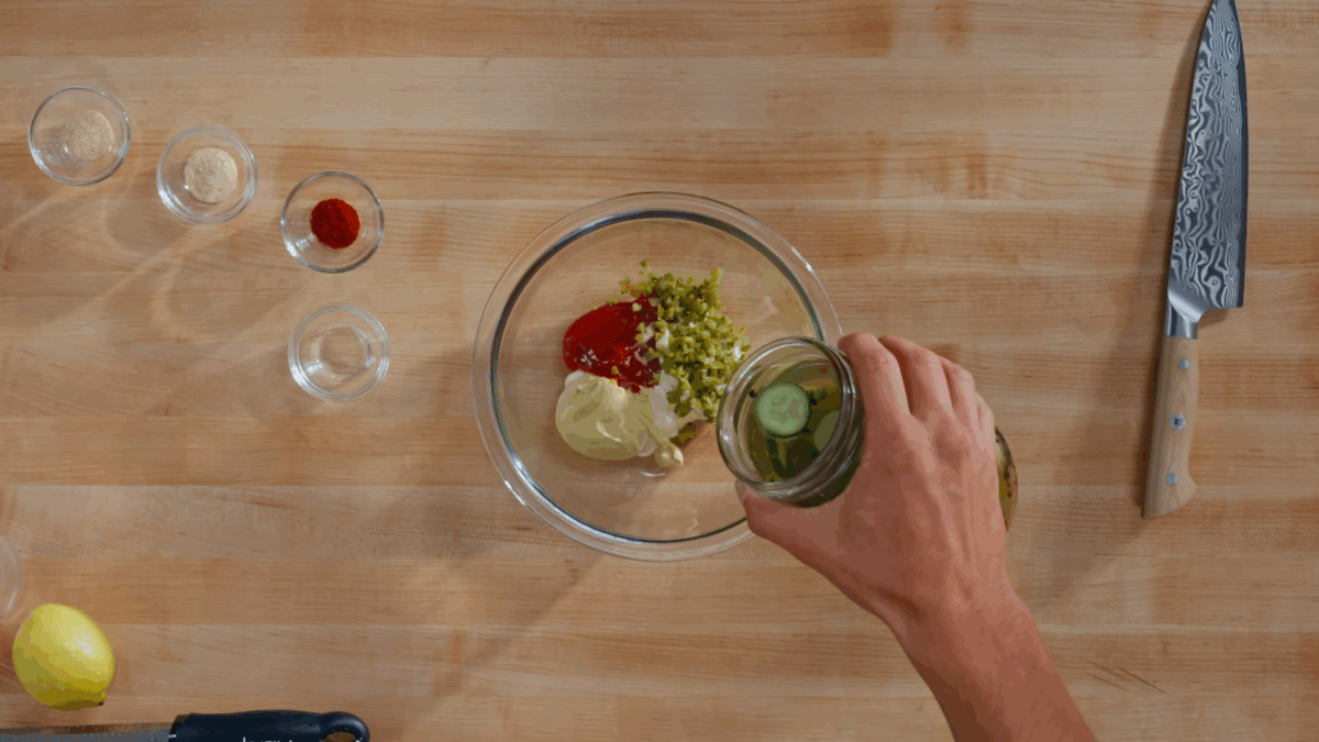 Nick DiGiovanni combining burger sauce ingredients in a bowl.