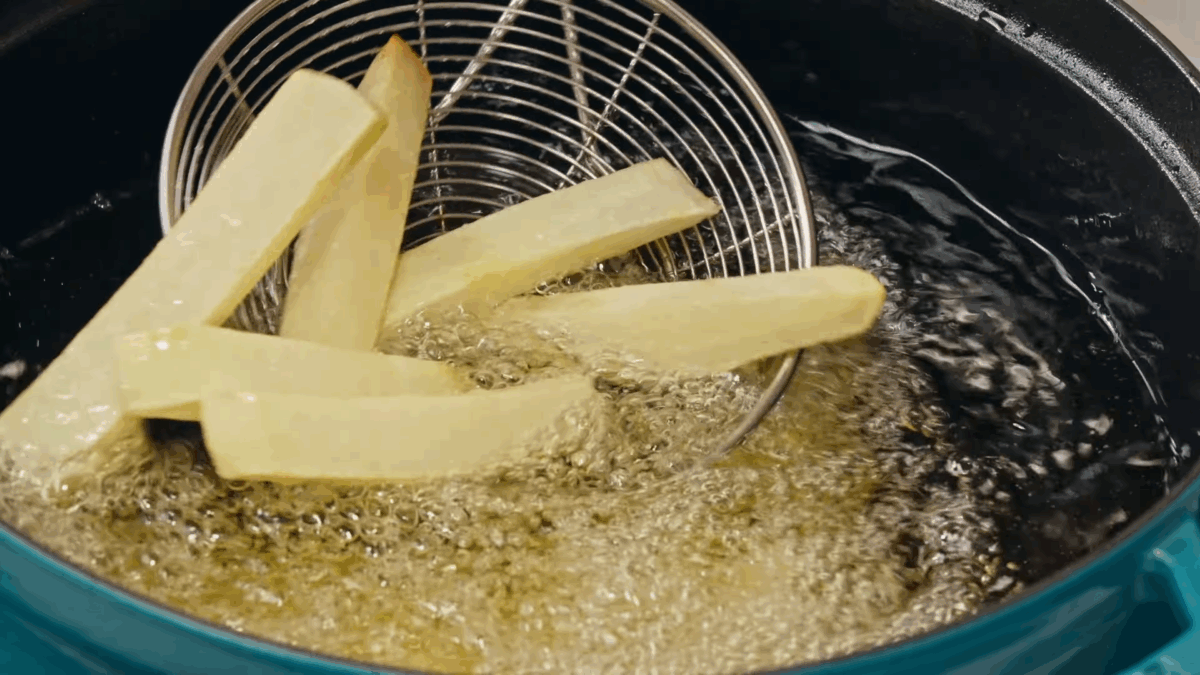 Nick DiGiovanni frying chips in oil.
