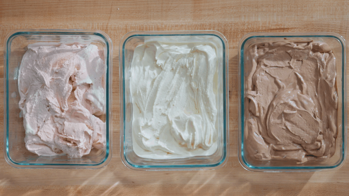 Strawberry ice cream, vanilla. ice cream, and chocolate ice cream in containers.