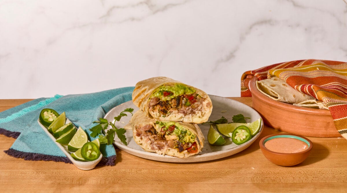 Two chicken burrito halves on a plate.