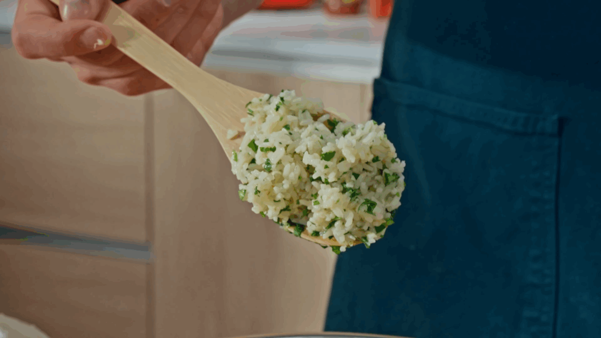 Nick DiGiovanni holding a spoonful of cilantro lime rice. 