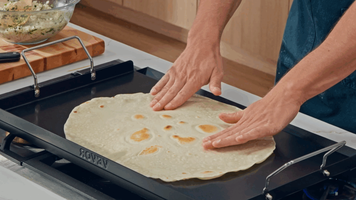 Nick DiGiovanni cooking a flour tortilla. 