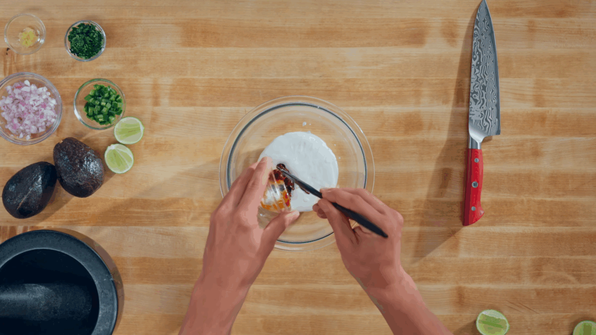 Nick DiGiovanni combining chipotle crema ingredients in a bowl. 