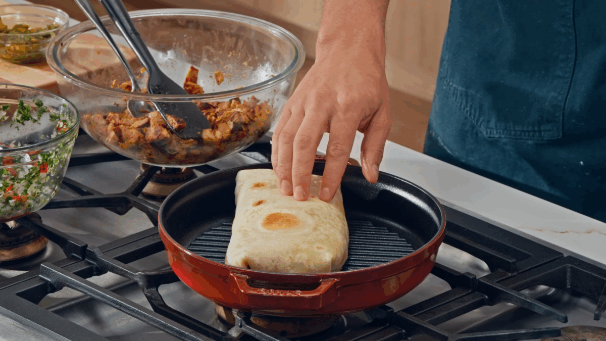 Nick DiGiovanni toasting a chicken burrito in a dry pan. 