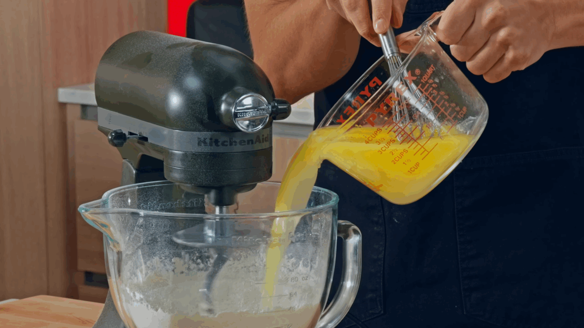 Nick DiGiovanni combining wet and dry ingredients in the bowl of a stand mixer. 
